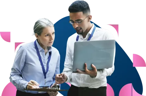 Business colleagues in professional attire reviewing documents together against abstract pink and blue background