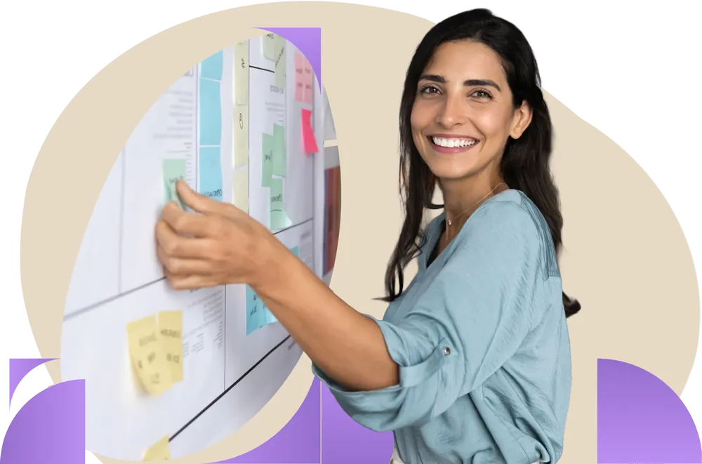 Person in blue shirt working on a kanban board with a happy expression