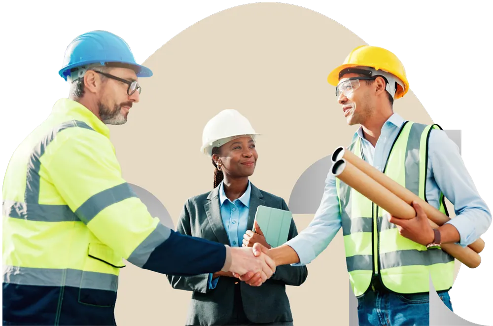 Construction workers and supervisor in safety gear exchanging handshakes at a worksite