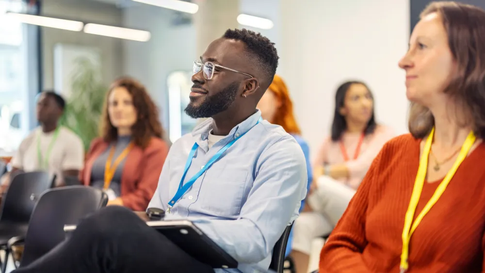 Attentive diverse audience listening during a conference in a bright room