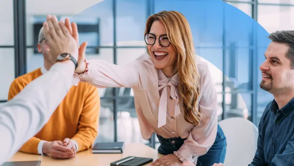 Cheerful business team celebrating success with a high-five