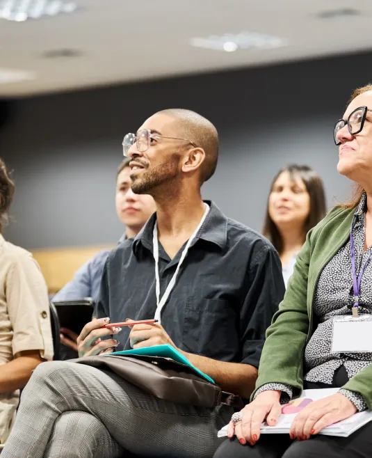 Group of diverse people sitting and attentively listening in a seminar room